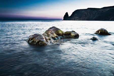 Landscape photo of rocks in the sea in sunsetの写真素材