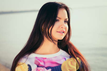 Young and beautiful woman in sunset light. lengthiest, beautiful hairの写真素材