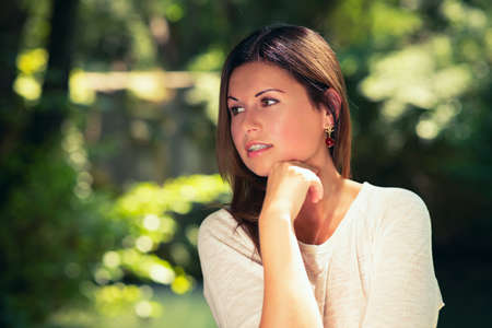 happy young woman  among green treesの写真素材