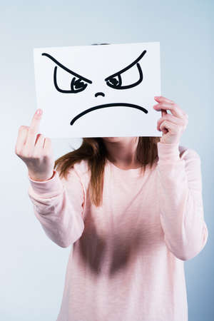 Angry young woman showing middle finger の写真素材