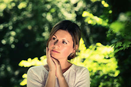 beautiful young woman among green trees. Vogue fashion style. Film, cinema frameの写真素材