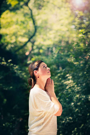 happy young woman  among green treesの写真素材