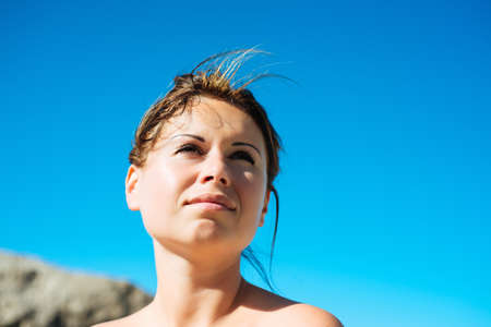 beautiful sunny portrait of a young woman enjoying summer sunの写真素材