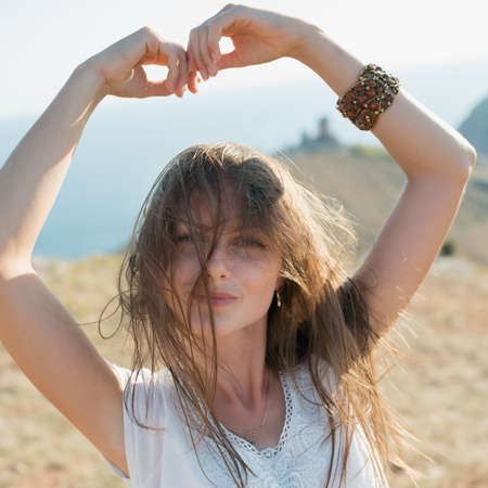 woman enjoying freedom and life on beautiful and magical sunset. relaxed and happy.の写真素材