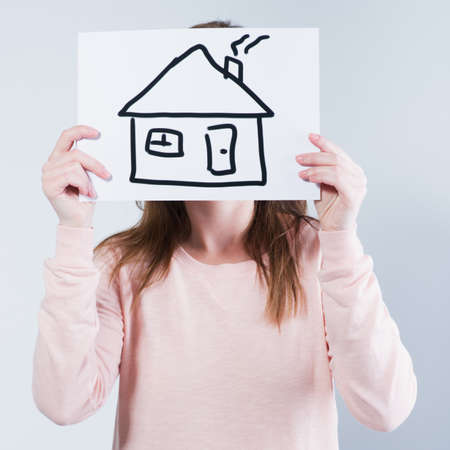 young woman holding picture with house. P の写真素材
