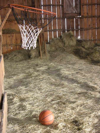 Basketball Hoop in empty barn Haymowの写真素材
