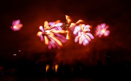 Abstract, blurry, bokeh-style colorful photo of fireworks above the river in New Yearの写真素材