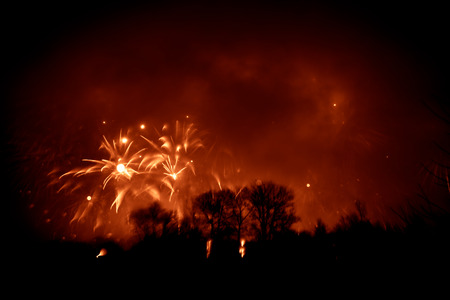 Abstract, blurry, bokeh-style colorful photo of fireworks above the river in New Yearの写真素材