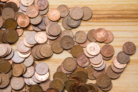 Old Latvian coins on a wooden backgrouns. Lats and centimes.の写真素材