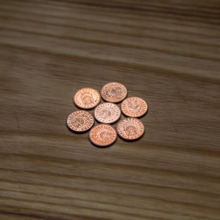 Old Latvian coins on a wooden backgrouns. Lats and centimes.の写真素材
