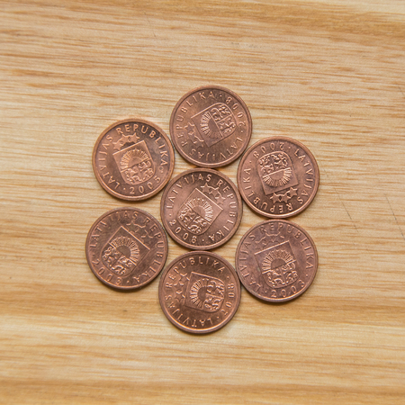 Old Latvian coins on a wooden backgrouns. Lats and centimes.