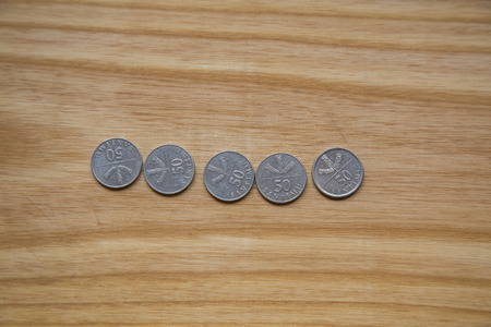 Old Latvian coins on a wooden backgrouns. Lats and centimes.の写真素材
