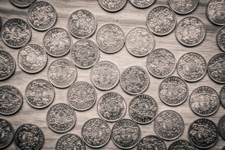 Anniversary lat coins of an old Latvian currency on a wooden backgroundの写真素材