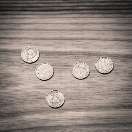 Old soviet couns on a wooden background. Hisoric, used currency.