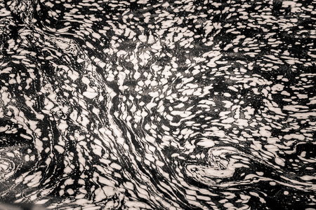 An abstract, monochrome pattern of river surface. Van Gogh style.の写真素材