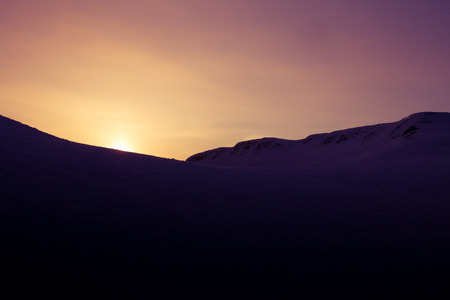 A beautiful, artistic, colorful sunset in Norway above mountains