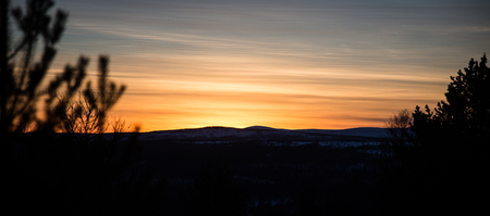 A beautiful, artistic, colorful sunset in Norway above mountainsの写真素材