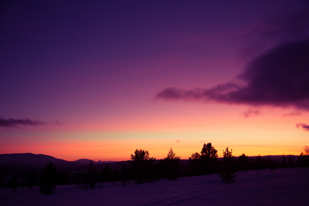 A beautiful, artistic, colorful sunset in Norway above mountainsの写真素材