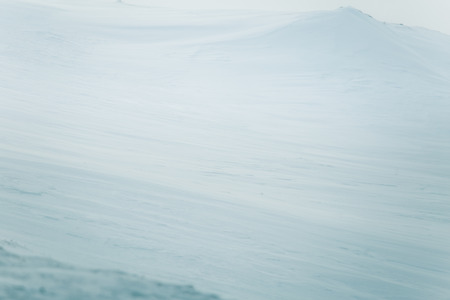 A beautiful, minimalist landscape of flat, snowy Norwegian field. Clean, light, high key, decorative look.の写真素材