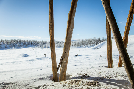 An old, abandoned copper mine building in the snowy Norway landscapeの写真素材