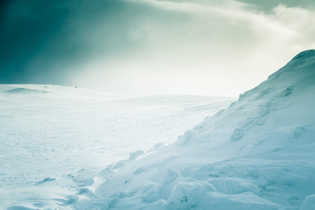 A beautiful, minimalist landscape of snowy Norwegian hills. Clean, light, high key, decorative look.