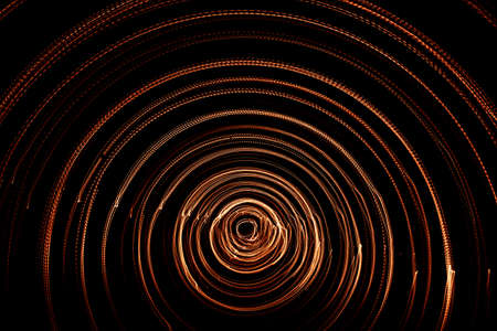 Colorful abstract trails of light. Dots, lines and bokeh on dark background. Long exposure.の写真素材