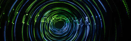Colorful abstract trails of light. Dots, lines and bokeh on dark background. Long exposure.