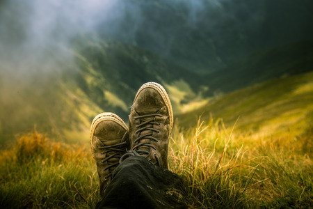 A traveller resting in a mountain landscape in Carpathian mountains, Romaniaの写真素材
