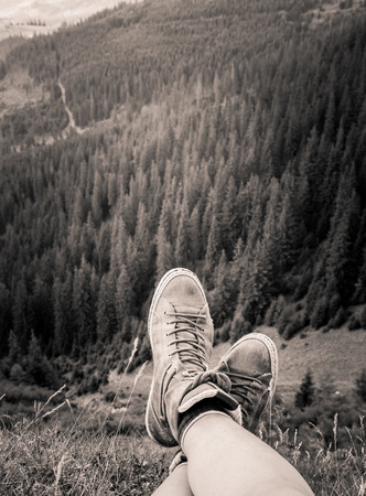 A traveller resting in a mountain landscape in Carpathian mountains, Romaniaの写真素材