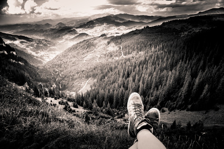 A traveller resting in a mountain landscape in Carpathian mountains, Romaniaの写真素材