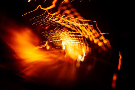 Red abstract trails of light on dark background. Long exposure.