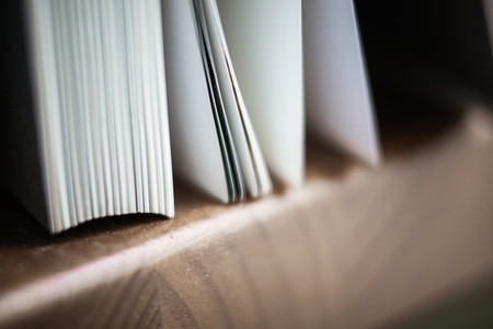 A beautiful closeup of a book in dark red cover and with red bookmark. Shallow depth of fieldの写真素材