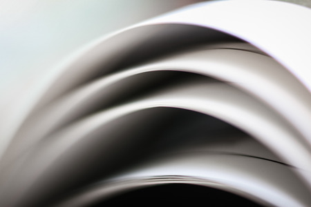 A beautiful closeup of a book in dark red cover and with red bookmark. Shallow depth of fieldの写真素材
