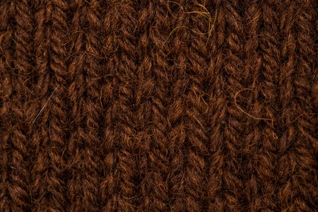 A beautiful closeup of a hand knitted warm and soft wool pattern. Soft socks or scarf of natural wool. Colorful pattern.の写真素材