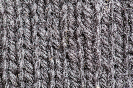 A beautiful closeup of a hand knitted warm and soft wool pattern. Soft socks or scarf of natural wool. Colorful pattern.の写真素材