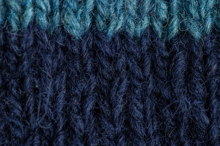 A beautiful closeup of a hand knitted warm and soft wool pattern. Soft socks or scarf of natural...