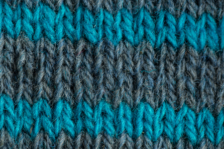 A beautiful closeup of a hand knitted warm and soft wool pattern. Soft socks or scarf of natural wool. Colorful pattern.の写真素材