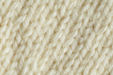 A beautiful closeup of a hand knitted warm and soft wool pattern. Soft socks or scarf of natural wool. Colorful pattern.の写真素材