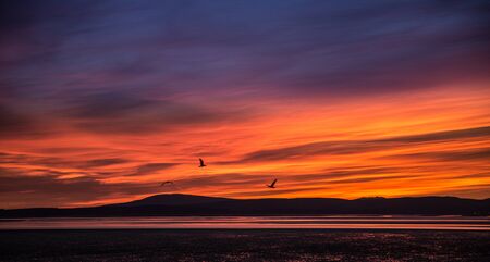 A beautiful colorful sunset view on the Morecambe beachの写真素材