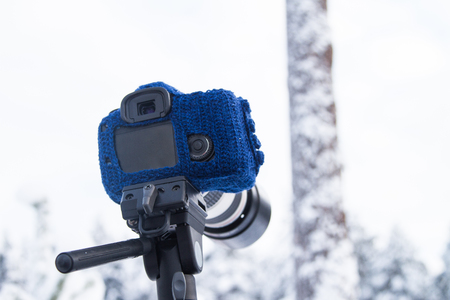 Hand knitted woolen mitten for DSLR camera for using in winterの写真素材