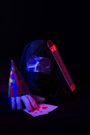 A colorful still life of an artificial skull and a female face statue. Blue and red studio lights and artistic compositionの写真素材