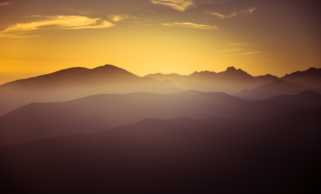 A beautiful, colorful, abstract mountain landscape in a mystic purple and orange tonality. Decorative, artistic look.の写真素材