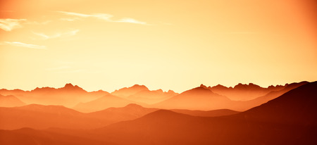 A beautiful, colorful, abstract mountain landscape in a red tonality. Decorative, artistic look.の写真素材