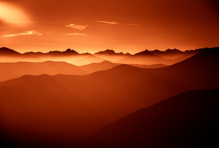 A beautiful, colorful, abstract mountain landscape in a red tonality. Decorative, artistic look.
