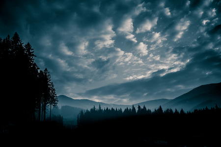 A beautiful, abstract monochrome mountain landscape in blue tonality. Decorative, artistic look in black and white style.の写真素材