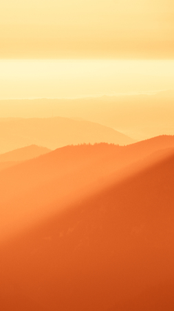 An inspiring mountain landscape in Tatry, Slovakia. Vivid, gradient scenery with perspective in red tone. Summer in mountains. Nature wallpaper in bright colors. A beautiful vertical wallpaper for a smartphone. Vertical image for a mobile use.の写真素材