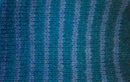 Colorful pattern ow a hand made wool socks. Natural clothing. Bright colors, close up pattern.