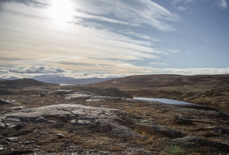 A beautiful mountain landscape with a lake in the distance. Autumn mountains in Norway. Fall scenery...