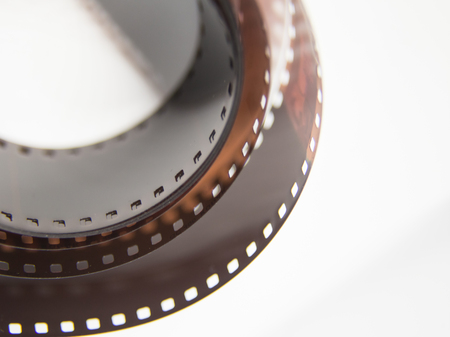 A beautiful closeup of an analogue photo film on a white background. Shallow depth of field.の写真素材
