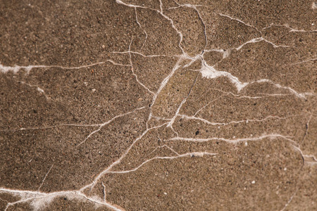 A grunge background of a concrete cracks. Closeup of an old army building wall at the coast of...